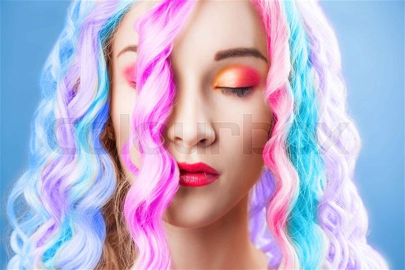 Beautiful woman wearing in colorful wig, stock photo