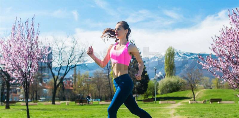 Woman running fast for sport on sunny day on a sunny day, stock photo