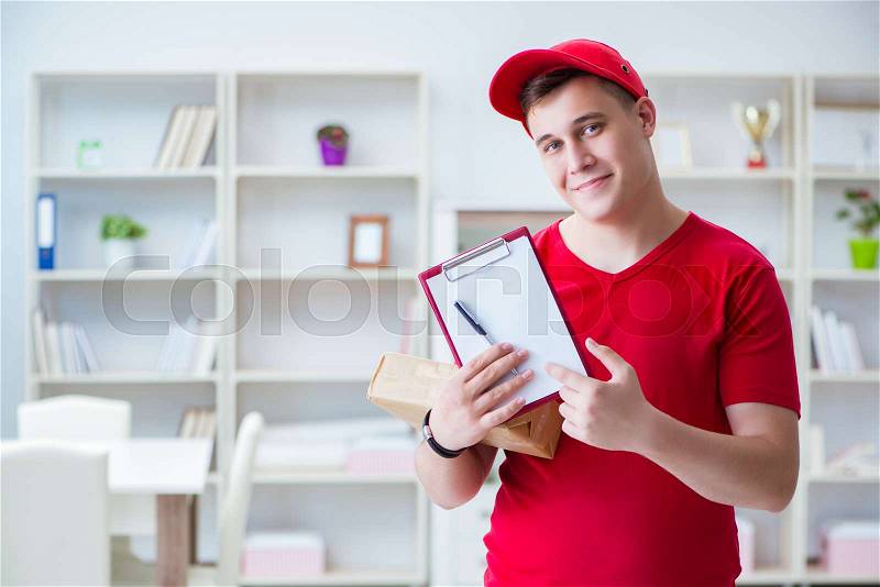 Post man delivering a parcel package, stock photo