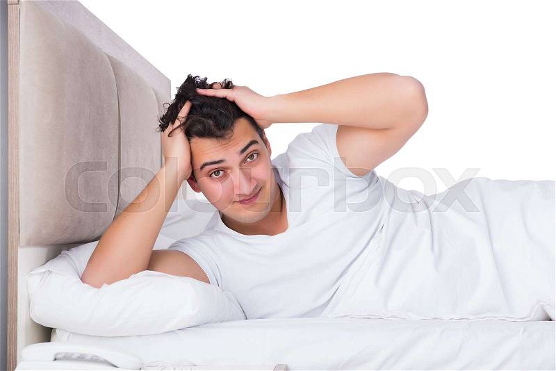 Man in bed suffering from insomnia, stock photo