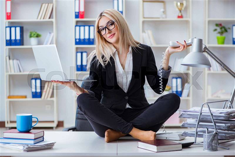 Businesswoman frustrated meditating in the office, stock photo
