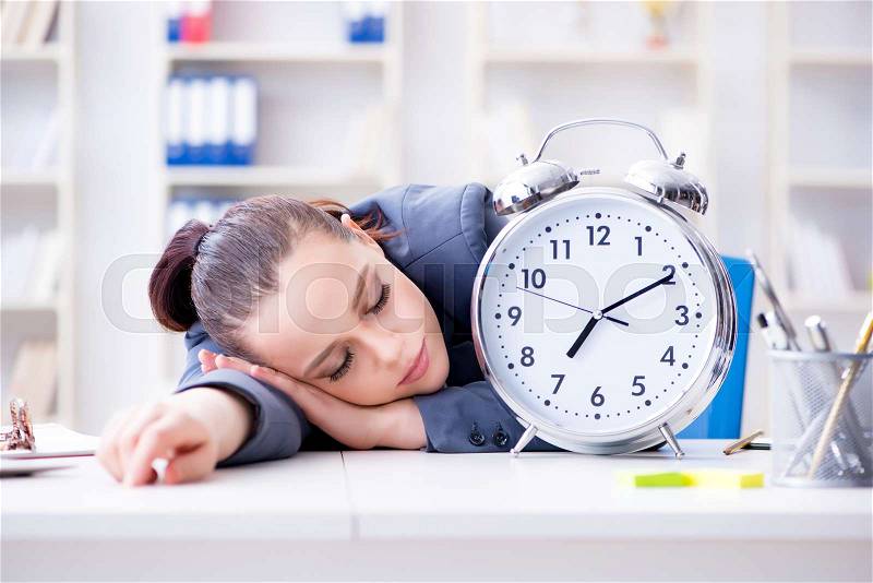 Businesswoman in time management concept sleeping, stock photo