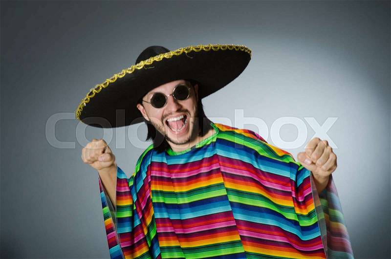 Man in a vivid mexican poncho gray background isolated, stock photo