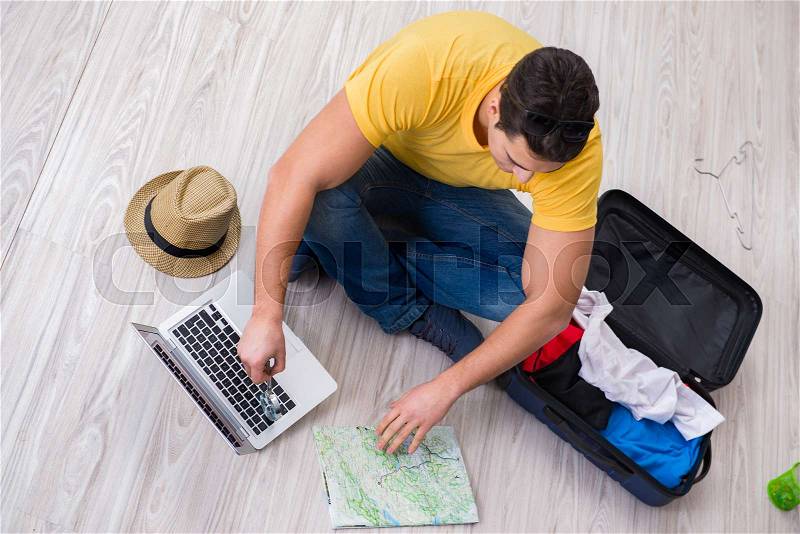 Man planning his vacation trip with map, stock photo
