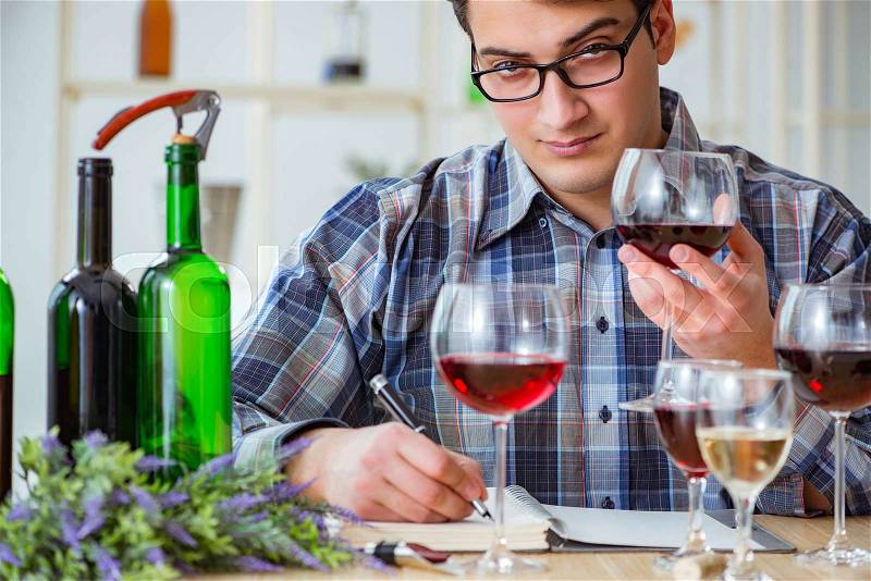 Professional sommelier tasting red wine , stock photo