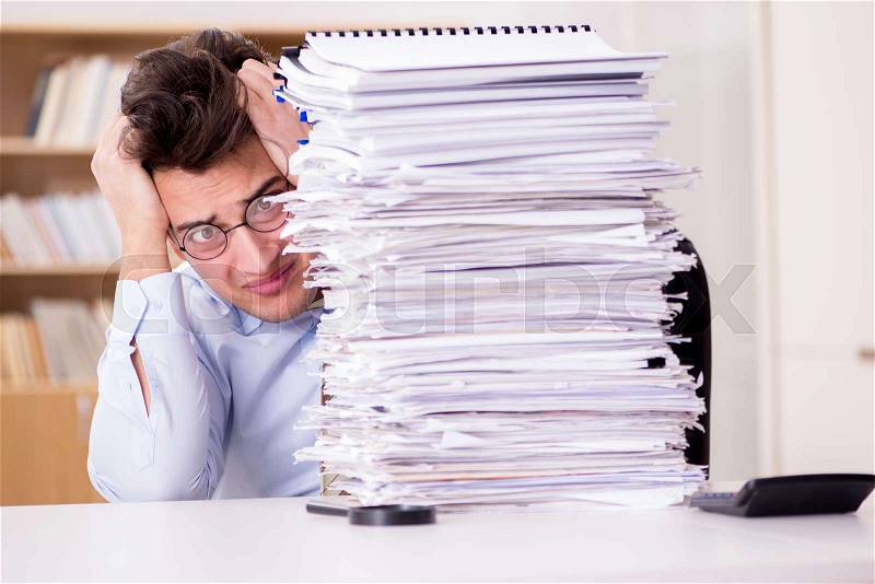 Mad businessman with piles of papers, stock photo