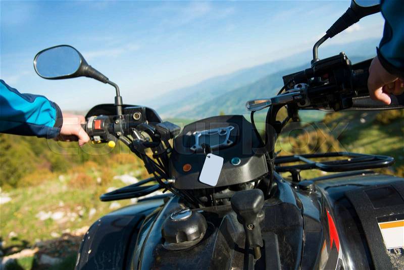 Young man on quad bike on a countryside trail. View from a quad bike, stock photo