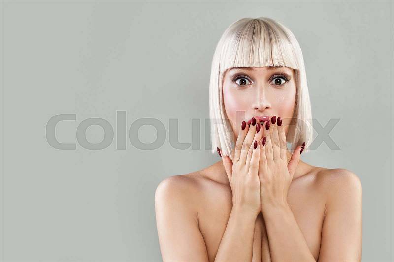 Happy Surprised Woman with Open Mouth. Blondie Model with Makeup and Bob Hairstyle on Banner Background, stock photo