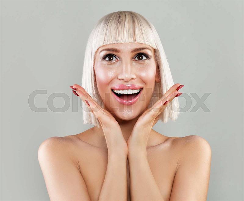 Surprised Woman with Open Mouth. Happy Blondie Model with Makeup and Bob Hairstyle, stock photo