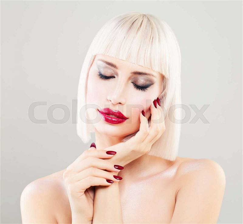Perfect Blonde Woman Fashion Model. Cute Girl with Blonde Bob Hairstyle, Makeup and Manicure, stock photo