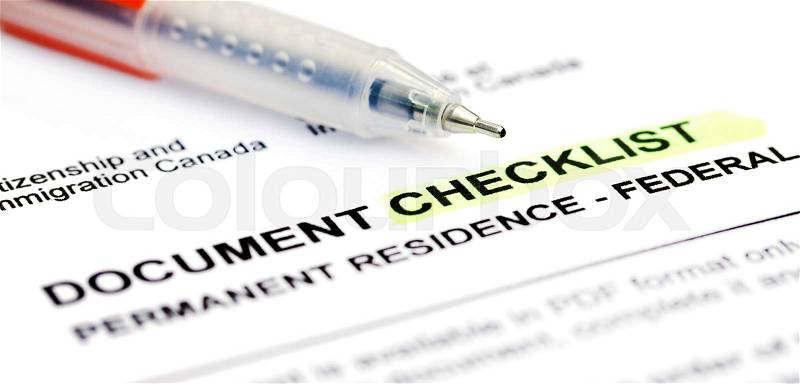Document checklist for Visa application Canada with a ballpoint, stock photo