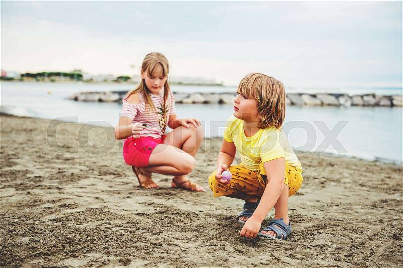 Cute little kids enjoying summer vacation by the sea. Image taken in Le Grau-du-Roi, Gard department, Camargue in Languedoc-Roussillon, France, stock photo