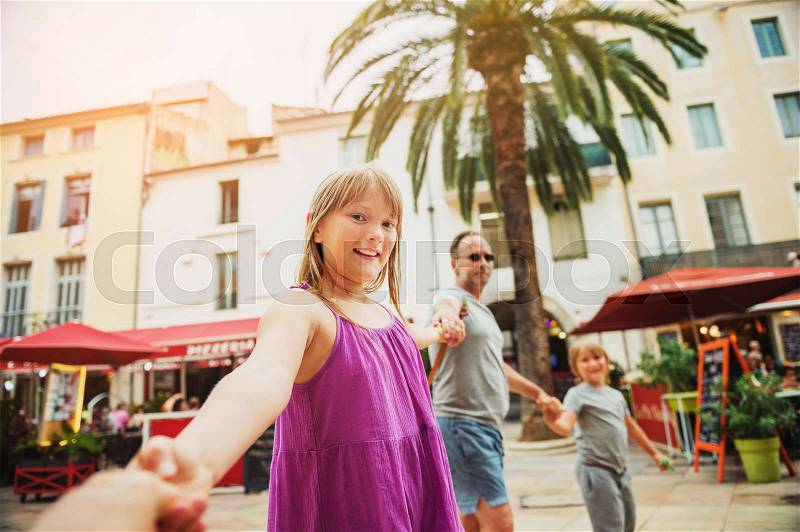 Follow me portrait of happy family enjoying summer vacation in Europe , stock photo