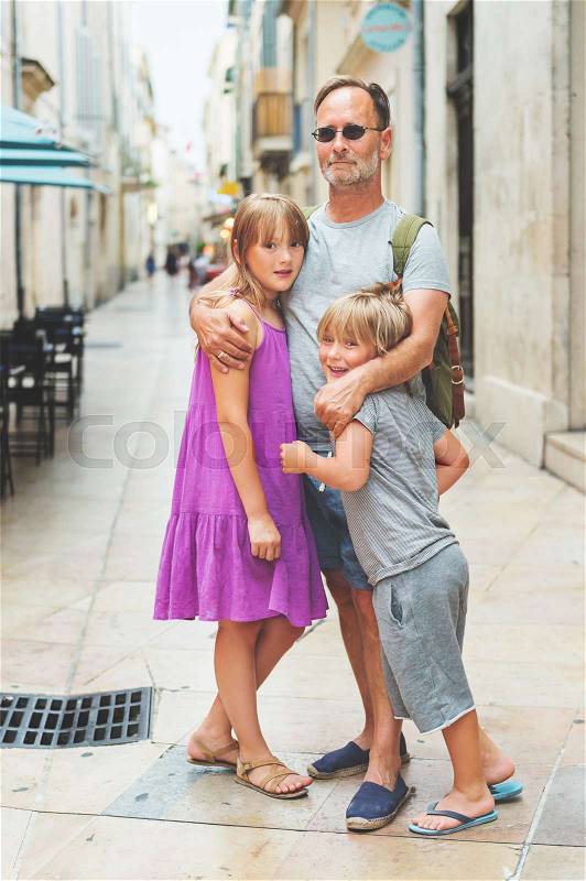 Portrait of happy family enjoying summer vacation in Europe , stock photo