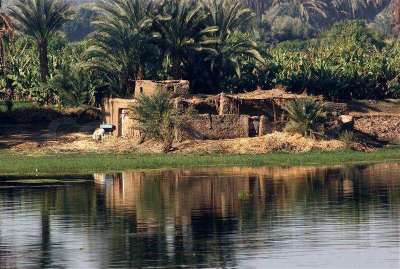 Waterside scenery at River Nile in Egypt Africa including needy cabins, stock photo