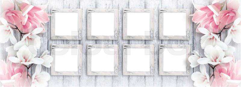 Eight retro empty photo frames with magnolia flowers on background of shabby wooden planks in rustic style, stock photo