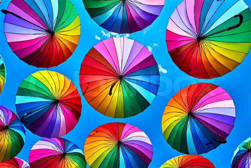 Rainbow umbrella on sky background. Many colorful umbrellas. umbrella street decoration, stock photo