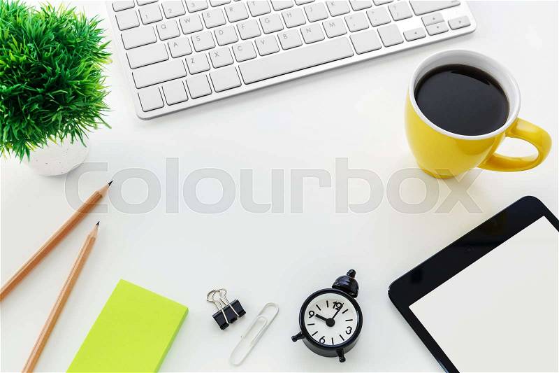 Modern office desk with computer coffee cup blank notepad pencil with copy space in the middle, stock photo