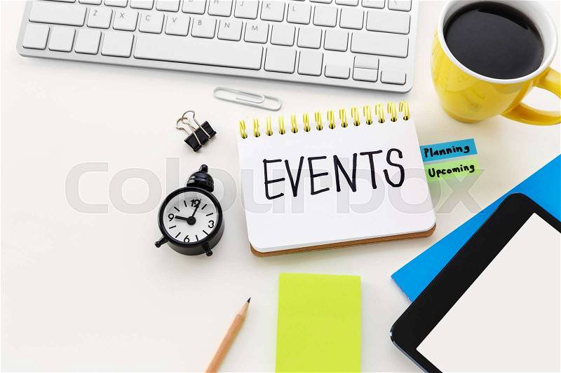 Event planning with clock notepad and coffee cup on computer office desk with space, stock photo