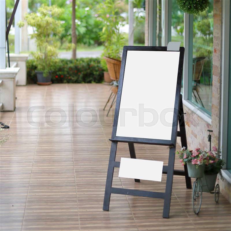 White empty blank menu board standing in front of restaurant cafe, stock photo