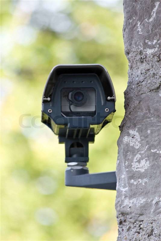 Surveillance camera on the wall, stock photo