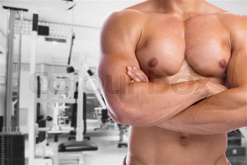 Bodybuilder bodybuilding flexing chest muscles posing fitness gym body builder building strong muscular man studio, stock photo
