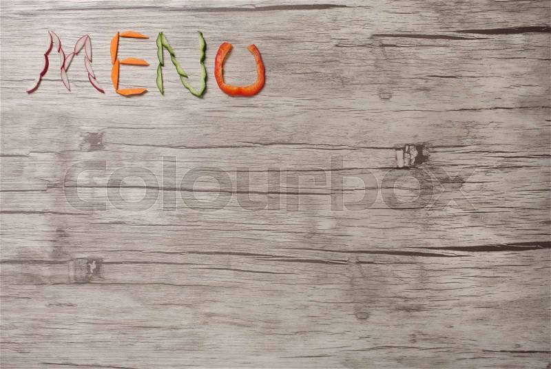 Menu title made of vegetables on wooden background, stock photo