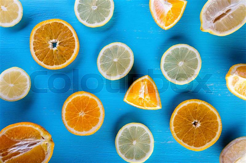 Blue background filled with sliced fruit. View from above. Summer still life. The concept of a rich harvest and healthy food, stock photo
