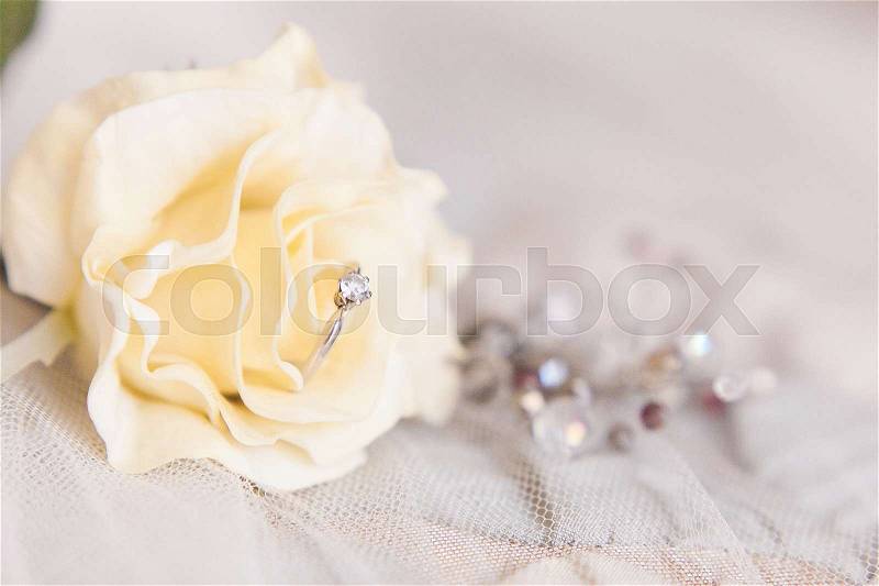Wedding rings of white gold and angage ring on white background, stock photo
