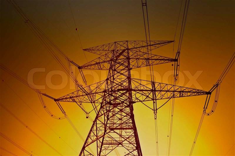 Electric power lines on the golden sky background, stock photo