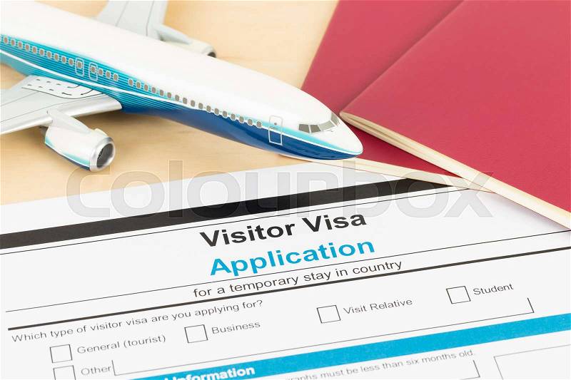 Visa application form with red passport, and plane, document is mock-up, stock photo