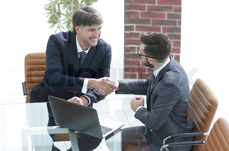 Hands shake between two successful business people concept of partnerships, stock photo