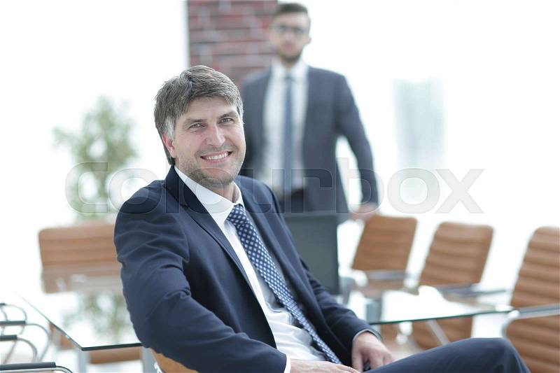 Business people. Businessman sitting in an empty conference room, stock photo