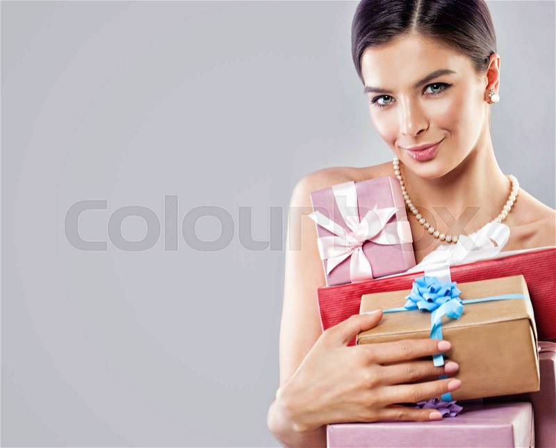 Beautiful Woman Fashion Model with Bright Gift Box on Banner Background, stock photo