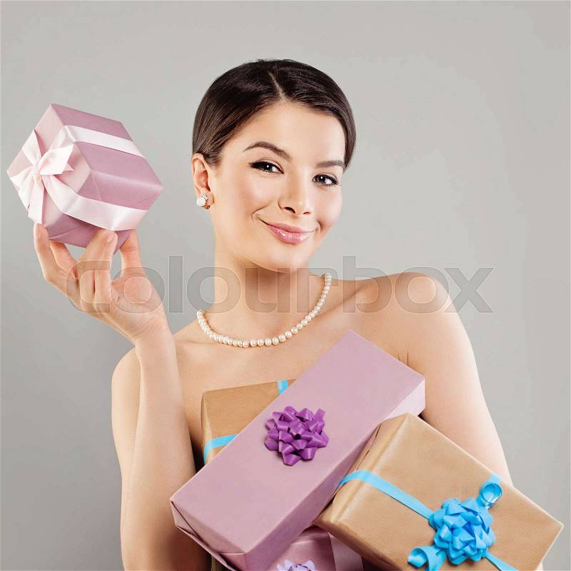 Happy Woman Fashion Model with Bright Gift Box on Banner Background, stock photo