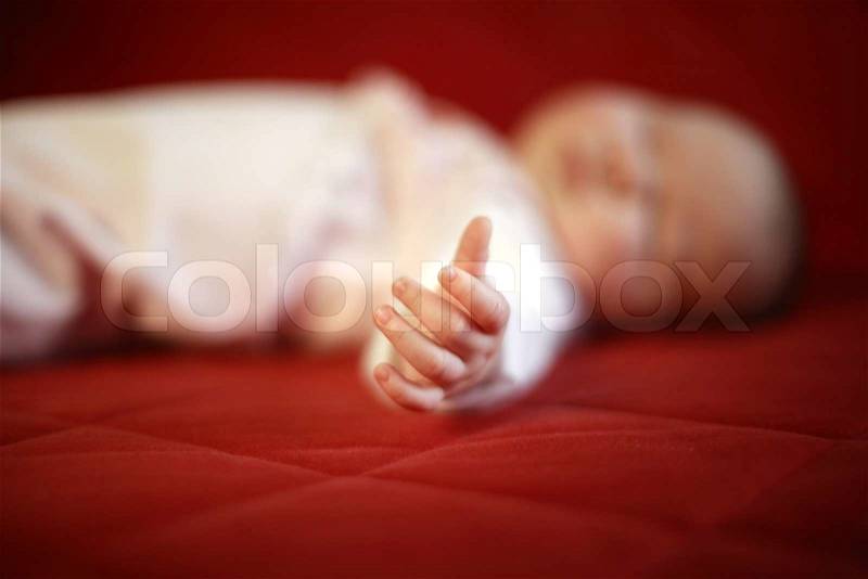 Detail of hand of sleeping baby - soft focus, stock photo