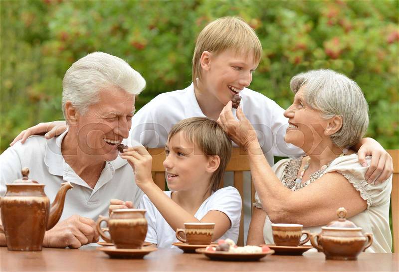 Portrait of a big happy family drinking tea outdoors, stock photo