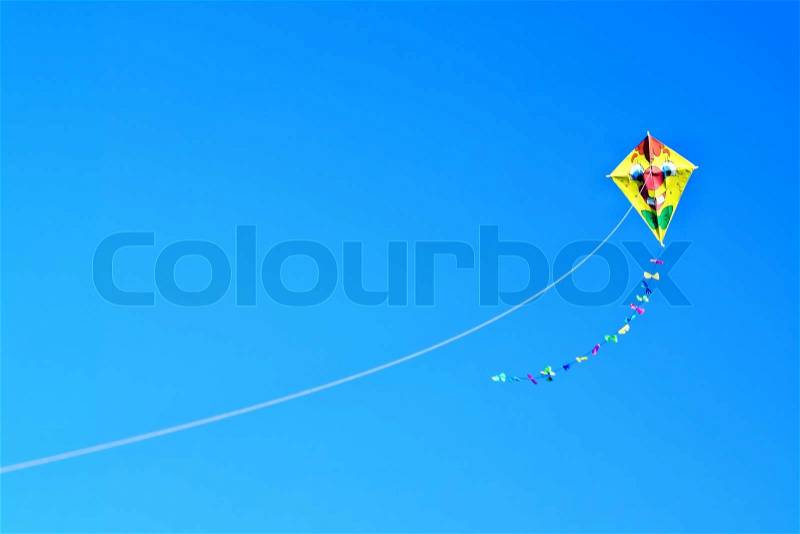 Colored kite sails on a clear blue sky, stock photo