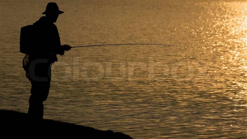 Fly fisherman´s golden hour - fishing in the sunset, stock photo