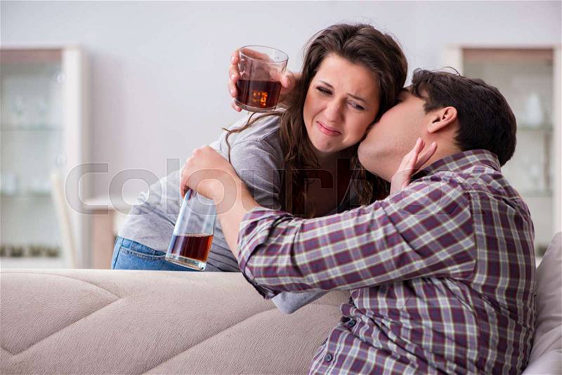 Domestic violence concept in a family argument with drunk alcoholic husband, stock photo