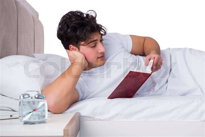 Man in bed suffering from insomnia, stock photo