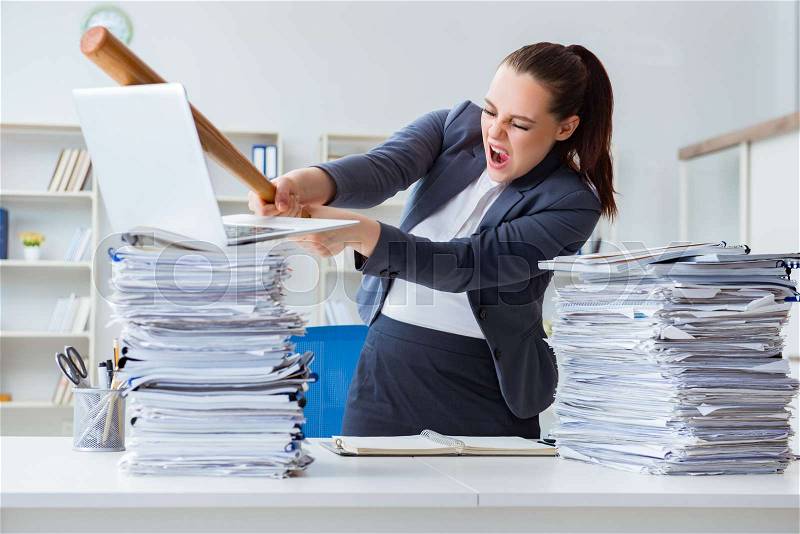 Angry businesswoman with baseball bat in office, stock photo