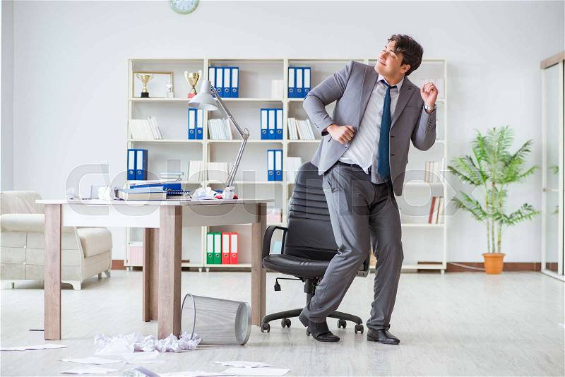 Businessman having fun taking a break in the office at work, stock photo
