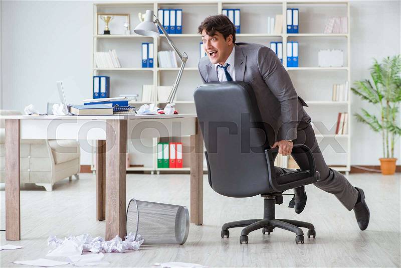 Businessman having fun taking a break in the office at work, stock photo