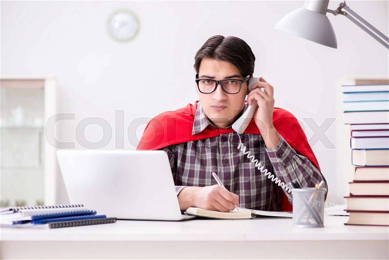 Super hero student with a laptop studying preparing for exams, stock photo