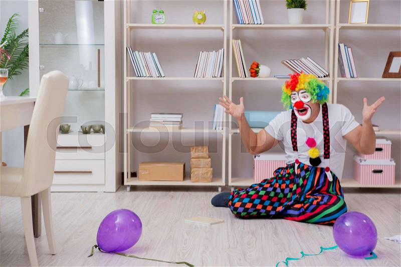 Drunk clown celebrating having a party at home, stock photo