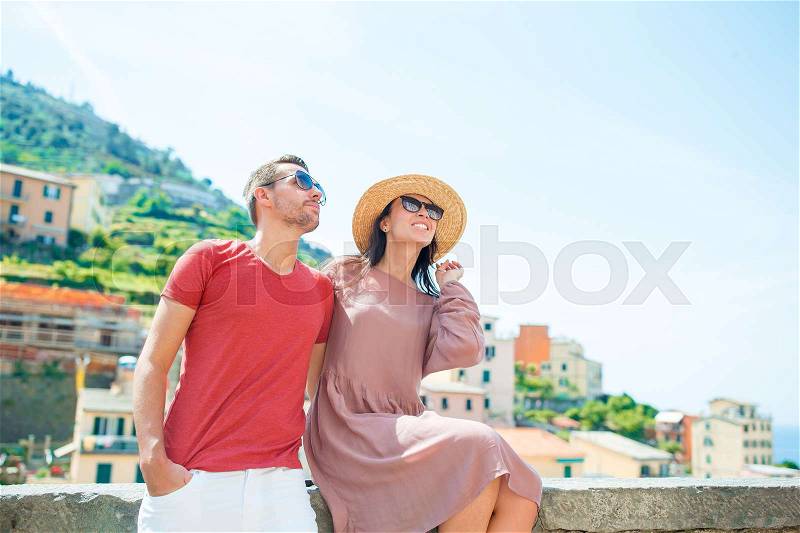 Happy couple with great view at old village Riomaggiore, Cinque Terre, Liguria, Italy. European italian vacation, stock photo