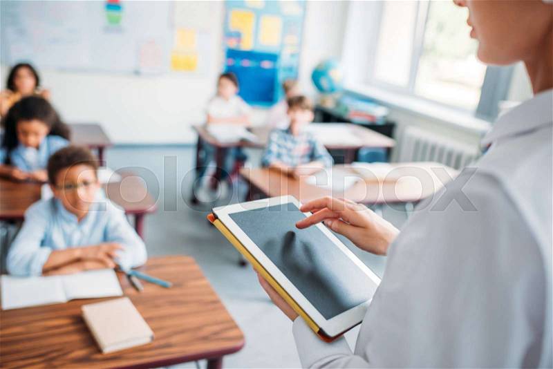 Teacher using digital tablet with blank screen, stock photo