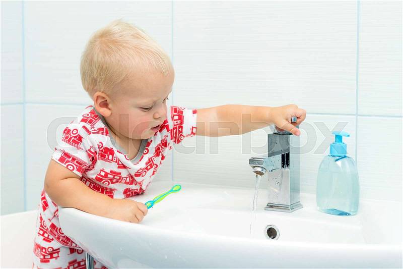 Cute toddler boy brushing teeth. Teeth cleaning, dental care. adorable baby boy washing up, stock photo
