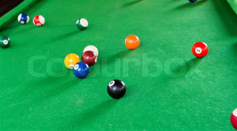 Billiard balls composition on green pool table, stock photo